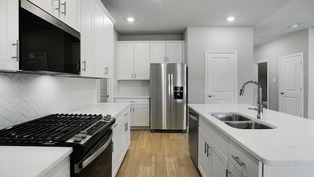 516 Willet Dr, Mckinney, TX 75069 - kitchen with appliances with stainless steel finishes, light wood-type flooring, light countertops, tasteful backsplash, and white cabinetry