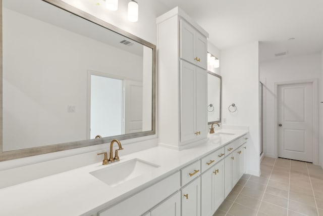 15792 Millwood Trl, Frisco, TX 75033 - bathroom featuring tile patterned flooring, double vanity, and a shower with shower door