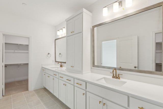 15792 Millwood Trl, Frisco, TX 75033 - bathroom featuring double vanity, a walk in closet, and tile patterned floors