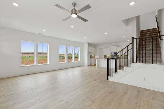15792 Millwood Trl, Frisco, TX 75033 - unfurnished living room featuring stairway, a ceiling fan, light wood-type flooring, and recessed lighting