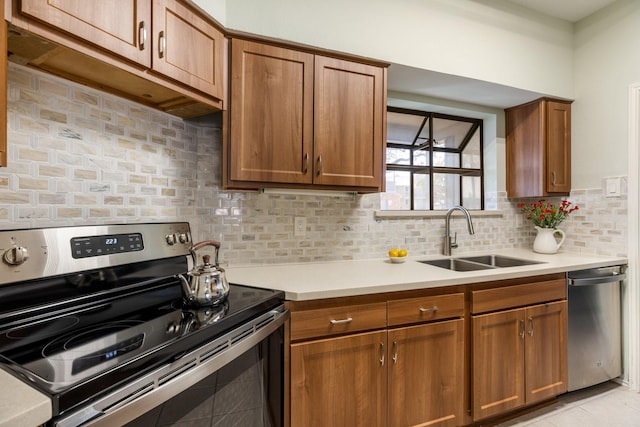 3101 Townbluff Dr Unit 1013, Plano, TX 75075 - kitchen with stainless steel appliances, a sink, light countertops, brown cabinets, and backsplash