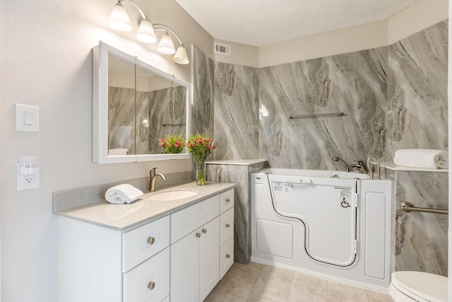 3101 Townbluff Dr Unit 1013, Plano, TX 75075 - bathroom with vanity, toilet, a textured ceiling, and tile patterned floors