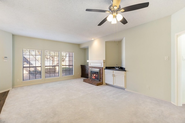 3101 Townbluff Dr Unit 1013, Plano, TX 75075 - unfurnished living room with light carpet, a fireplace, ceiling fan, baseboards, and a textured ceiling