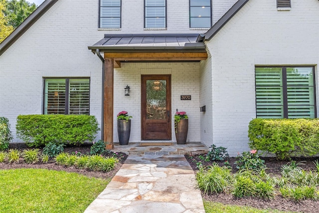 3970 Cobblestone Cir, Dallas, TX 75229 - doorway to property with a standing seam roof, brick siding, and metal roof
