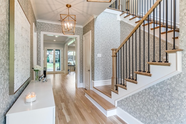 3970 Cobblestone Cir, Dallas, TX 75229 - foyer with wallpapered walls, crown molding, wood finished floors, stairway, and a chandelier