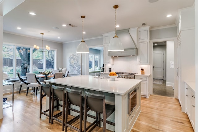 3970 Cobblestone Cir, Dallas, TX 75229 - kitchen with custom range hood, stainless steel microwave, light countertops, white cabinets, and recessed lighting