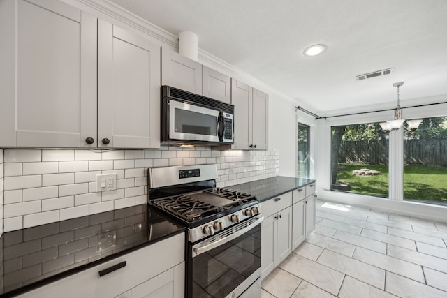 2207 Oakwood Ln, Arlington, TX 76012 - kitchen with stainless steel appliances, decorative backsplash, crown molding, light tile patterned floors, and pendant lighting
