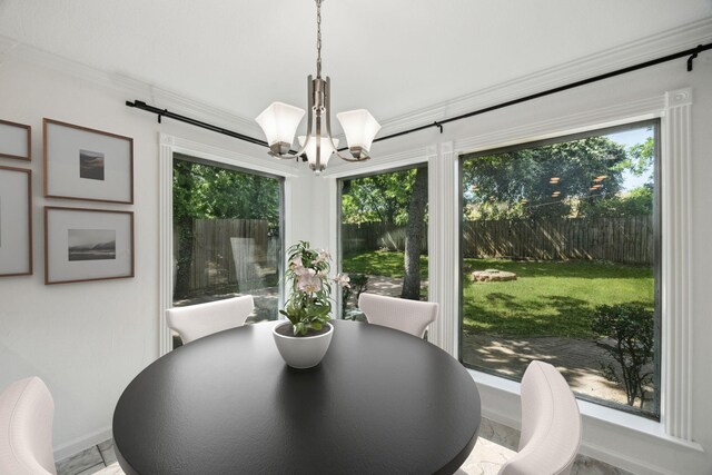 2207 Oakwood Ln, Arlington, TX 76012 - dining area with baseboards, a chandelier, and ornamental molding
