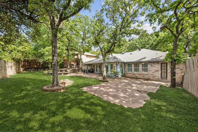 2207 Oakwood Ln, Arlington, TX 76012 - rear view of property with a patio, brick siding, and roof with shingles
