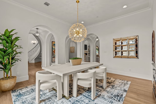 2210 Barcelona Ct, Westlake, TX 76262 - dining space featuring arched walkways, a chandelier, light wood-type flooring, crown molding, and recessed lighting