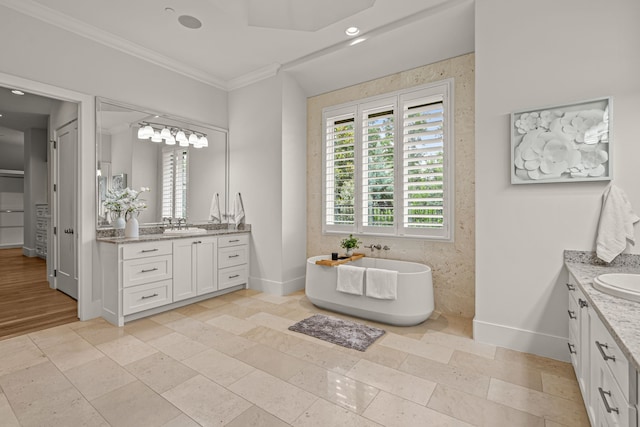 2210 Barcelona Ct, Westlake, TX 76262 - full bathroom featuring two vanities, ornamental molding, baseboards, a soaking tub, and recessed lighting