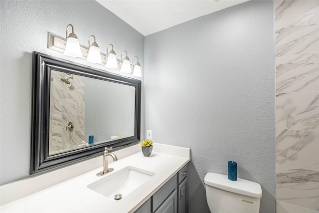 13561 Waterfall Way, Dallas, TX 75240 - bathroom with toilet, tiled shower, vanity, and a textured wall