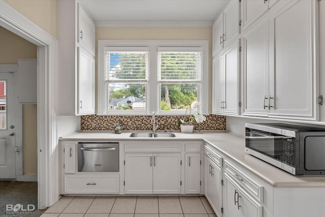kitchen featuring dishwasher, a sink, white cabinets, and ornamental molding