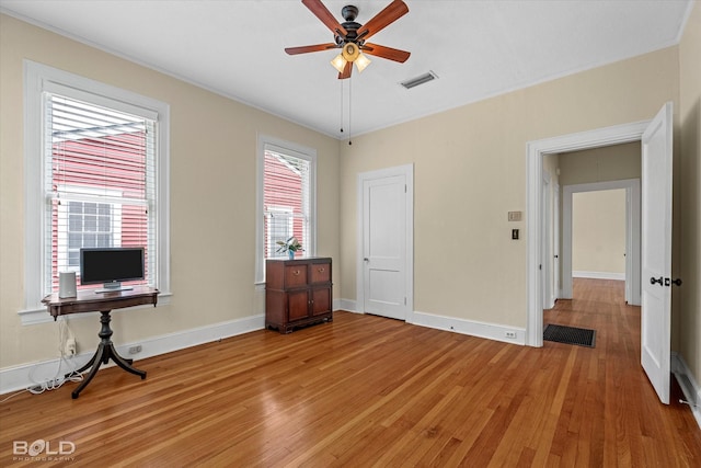 bedroom featuring light wood-type flooring, baseboards, and ornamental molding