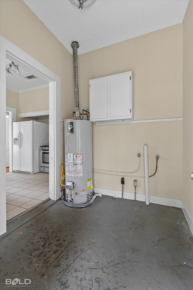 garage featuring water heater, white fridge with ice dispenser, and baseboards