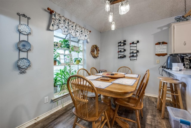 425 Headlee St, Denton, TX 76201 - dining area featuring a textured ceiling, dark wood-style floors, and baseboards