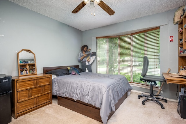 425 Headlee St, Denton, TX 76201 - bedroom with light colored carpet, multiple windows, a textured ceiling, baseboards, and a ceiling fan