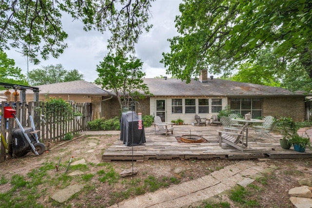 425 Headlee St, Denton, TX 76201 - rear view of property with a wooden deck, a fire pit, fence, and a chimney
