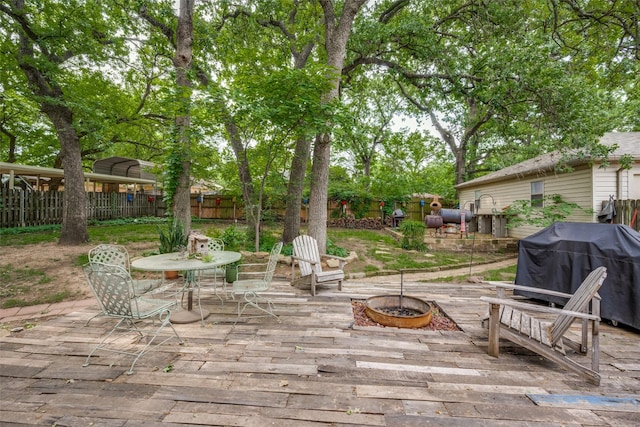 425 Headlee St, Denton, TX 76201 - deck with a fenced backyard, outdoor dining space, a fire pit, and a grill