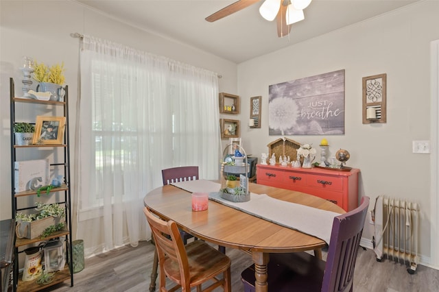 211 S Wickham St, Alvord, TX 76225 - dining area featuring radiator heating unit, a ceiling fan, wood finished floors, and baseboards