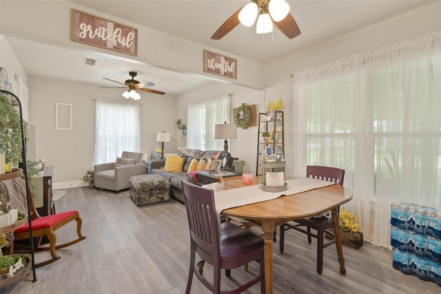 211 S Wickham St, Alvord, TX 76225 - dining area featuring a ceiling fan, light wood-style flooring, and baseboards