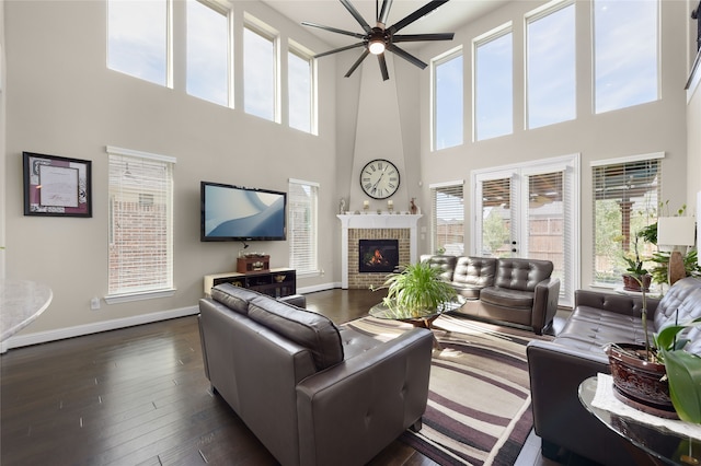 215 Dominion Dr, Wylie, TX 75098 - living area featuring ceiling fan, a towering ceiling, healthy amount of natural light, baseboards, and dark wood-type flooring