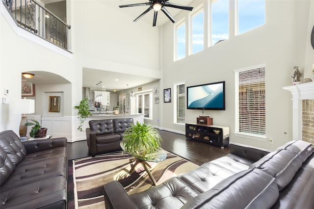 215 Dominion Dr, Wylie, TX 75098 - living area with ceiling fan, hardwood / wood-style flooring, a towering ceiling, and arched walkways