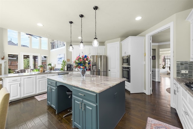 215 Dominion Dr, Wylie, TX 75098 - kitchen with appliances with stainless steel finishes, a kitchen island, white cabinetry, recessed lighting, and a peninsula