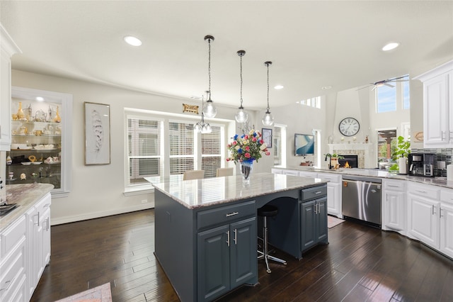 215 Dominion Dr, Wylie, TX 75098 - kitchen with stainless steel dishwasher, a kitchen island, a ceiling fan, white cabinetry, and recessed lighting