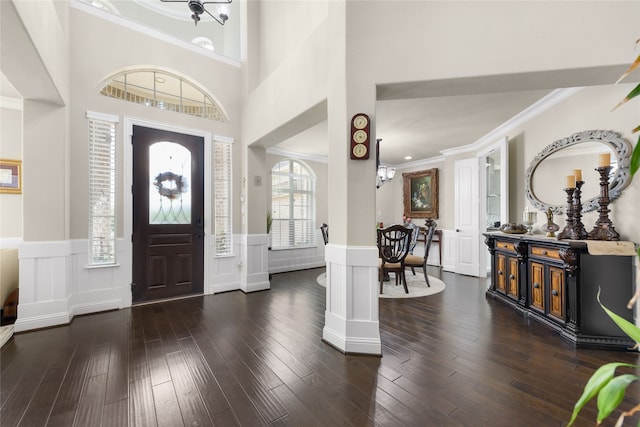 215 Dominion Dr, Wylie, TX 75098 - entryway with ornamental molding, a wainscoted wall, a decorative wall, and wood finished floors