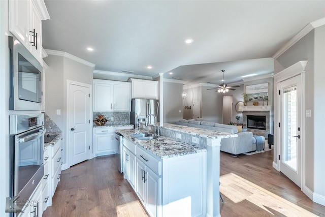 6709 Tradition Dr, Abilene, TX 79606 - kitchen with appliances with stainless steel finishes, a sink, ornamental molding, healthy amount of natural light, and white cabinetry