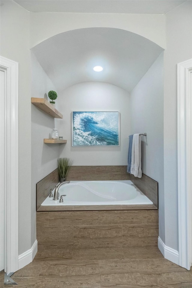 6709 Tradition Dr, Abilene, TX 79606 - bathroom with wood finished floors, a bath, and baseboards