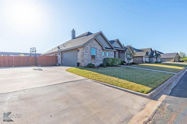 6709 Tradition Dr, Abilene, TX 79606 - view of front facade with brick siding, concrete driveway, an attached garage, and a chimney