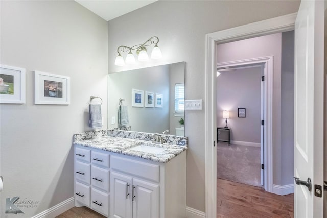 6709 Tradition Dr, Abilene, TX 79606 - bathroom with wood finished floors, vanity, and baseboards