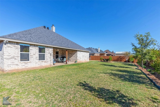 6709 Tradition Dr, Abilene, TX 79606 - back of house featuring a patio area, brick siding, a chimney, and a shingled roof