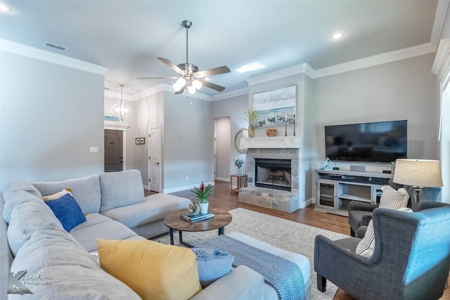 6709 Tradition Dr, Abilene, TX 79606 - living area with wood finished floors, ceiling fan, baseboards, crown molding, and a stone fireplace