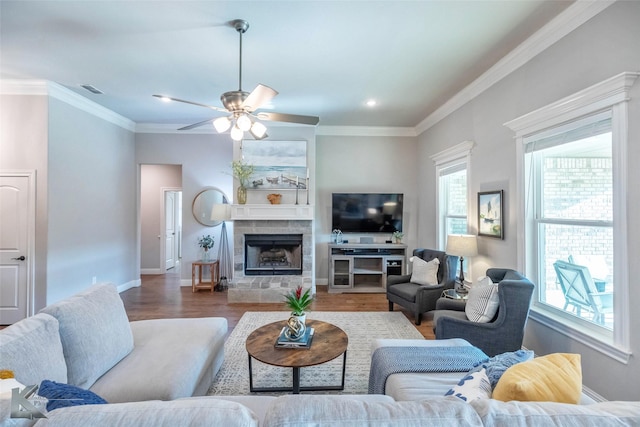 6709 Tradition Dr, Abilene, TX 79606 - living area with wood finished floors, baseboards, ornamental molding, ceiling fan, and a tile fireplace