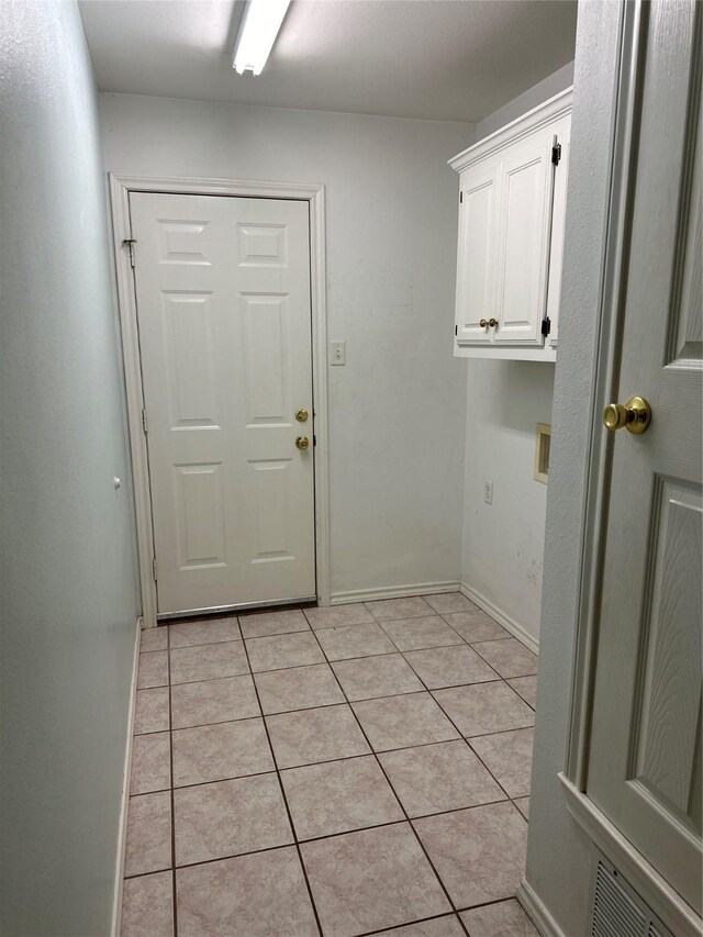 804 Austin Acre, Sulphur Springs, TX 75482 - clothes washing area with cabinet space, light tile patterned floors, washer hookup, and baseboards