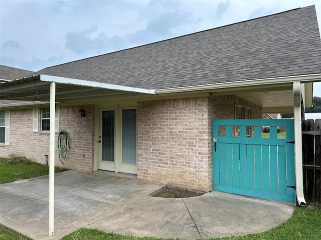 804 Austin Acre, Sulphur Springs, TX 75482 - entrance to property featuring a shingled roof, brick siding, fence, and a gate