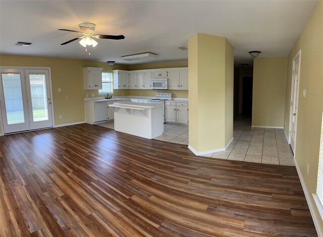 804 Austin Acre, Sulphur Springs, TX 75482 - kitchen with white appliances, wood finished floors, light countertops, and white cabinets