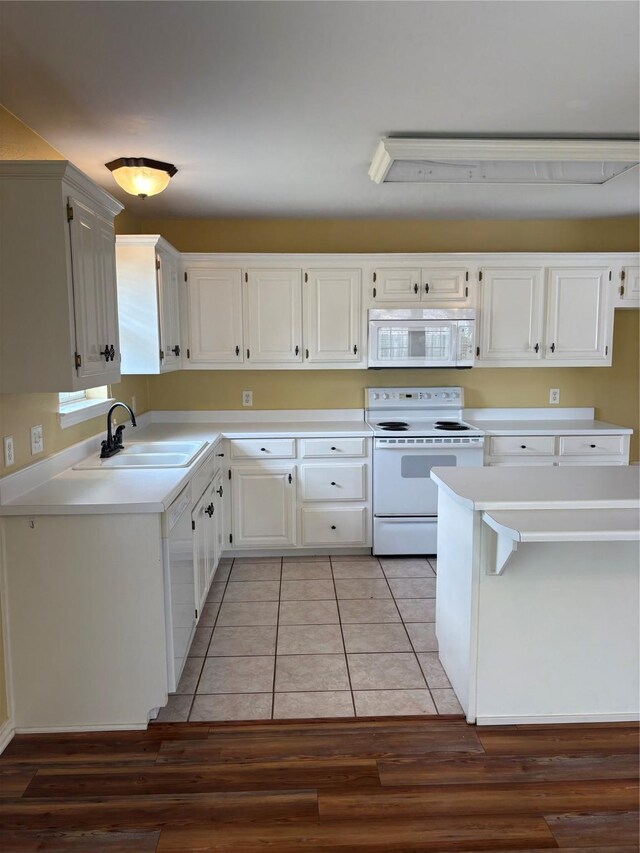 804 Austin Acre, Sulphur Springs, TX 75482 - kitchen featuring white appliances, a sink, light countertops, and white cabinets