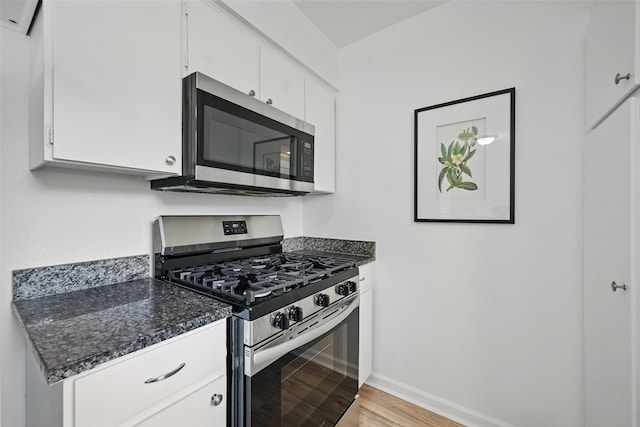629 Chambers St, Denton, TX 76205 - kitchen with appliances with stainless steel finishes, white cabinets, light wood-type flooring, and baseboards