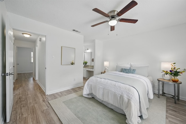 629 Chambers St, Denton, TX 76205 - bedroom featuring light wood-style floors, baseboards, a ceiling fan, and ensuite bathroom