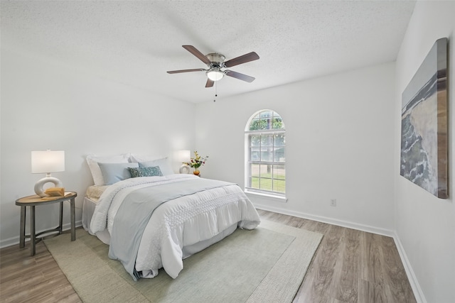 629 Chambers St, Denton, TX 76205 - bedroom with wood finished floors, baseboards, a textured ceiling, and ceiling fan