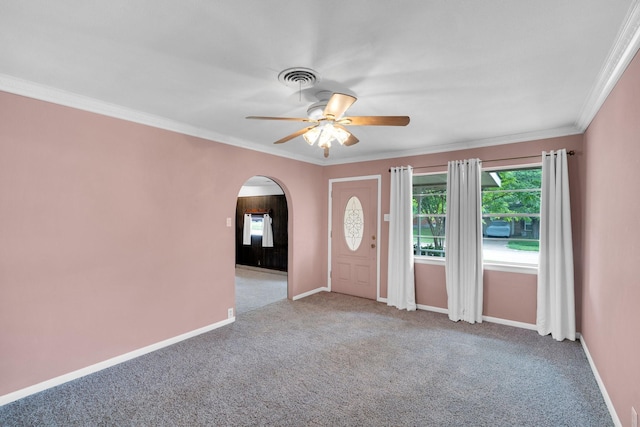 510 Allen Ave, Duncanville, TX 75137 - carpeted foyer featuring arched walkways, ceiling fan, baseboards, and crown molding