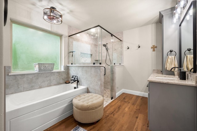 422 Sundance, Corsicana, TX 75109 - bathroom with a bath, vanity, wood finished floors, and a shower stall