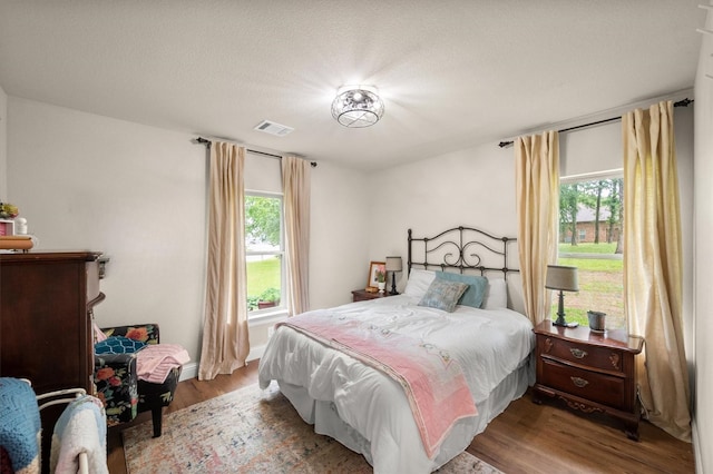 422 Sundance, Corsicana, TX 75109 - bedroom featuring wood finished floors and multiple windows