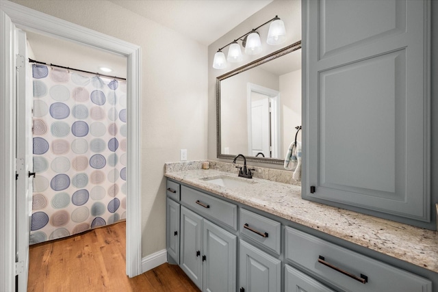 422 Sundance, Corsicana, TX 75109 - full bath featuring vanity, wood finished floors, baseboards, and a shower with curtain