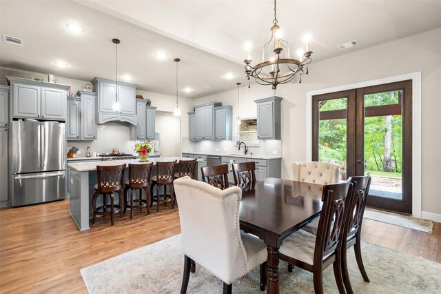 422 Sundance, Corsicana, TX 75109 - dining area featuring light wood-type flooring, a chandelier, french doors, and recessed lighting