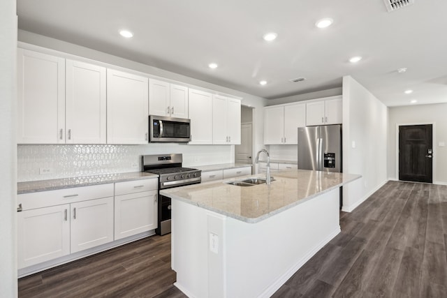 418 Stagg St, Mckinney, TX 75069 - kitchen with appliances with stainless steel finishes, a sink, white cabinetry, an island with sink, and dark wood-type flooring